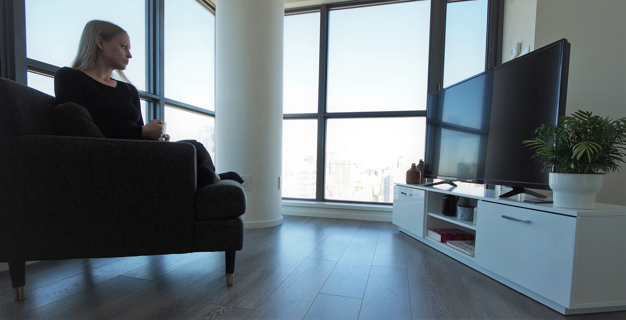 Contemporary TV Stands on sale now , woman in living room with modern white TV Stand